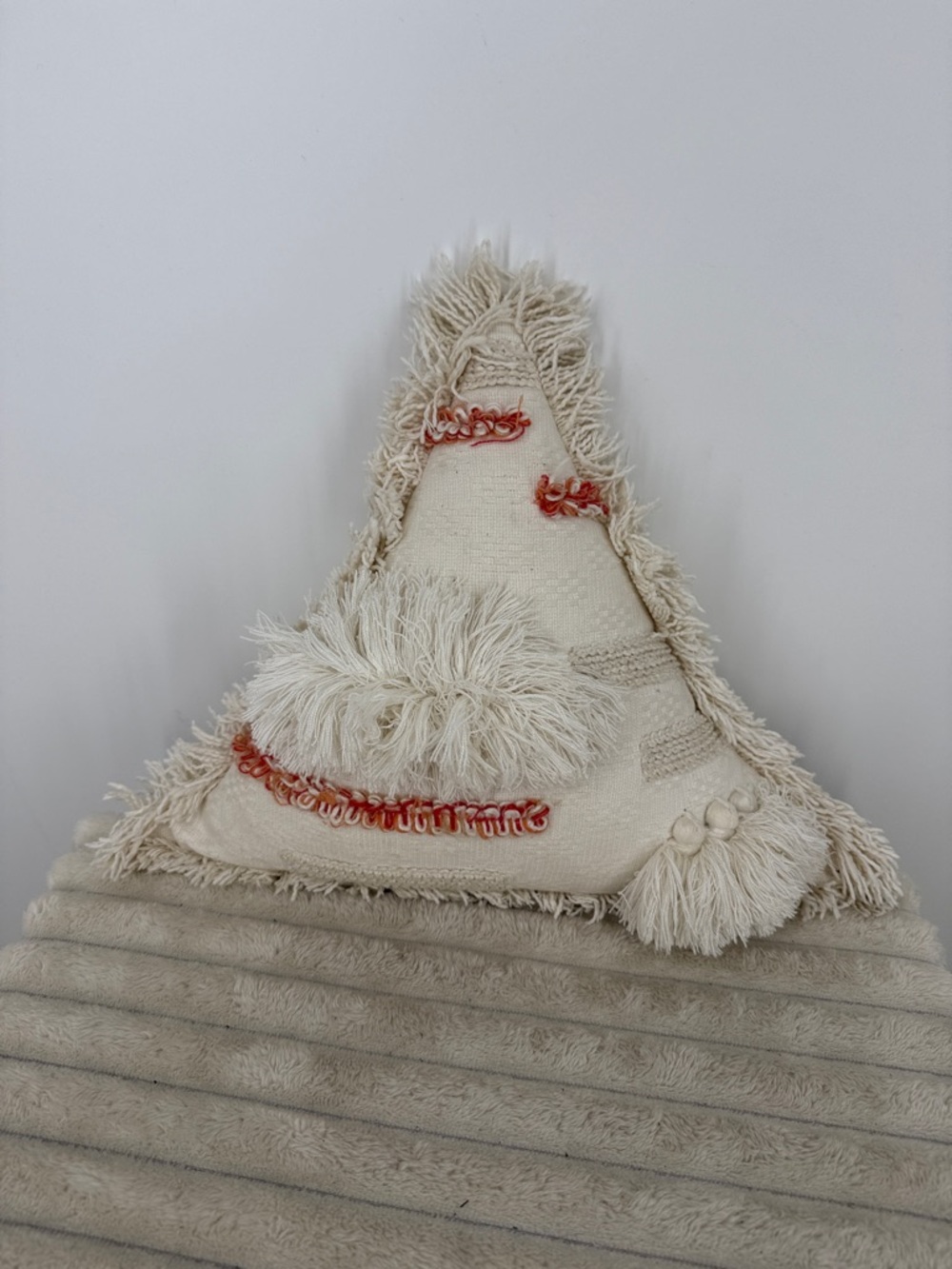 Neutral Cream Triangle Fringe Accent Pillow with Coral Stitching